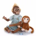 Lifelike reborn orangutan baby doll with plush monkey toy and pacifier on white background - Striped Shirt Overalls Version / Blue