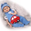 Realistic reborn baby doll in blue three-piece car outfit on plush carpet background - 55 cm / Blue