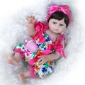 Lifelike 48cm reborn baby doll with blue eyes and clover print outfit on white fur - Pink