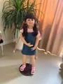 Detail of 98cm girl doll featuring dark brown pigtails with floral hair accessories - Realistic Toddler Girl Style (1905) / Pink / Large Size