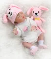 Sleeping reborn baby doll wearing a pink rabbit hat and a huggable heart onesie - Pink / Closed Eyes