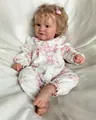Close-up of 60cm reborn doll Maddie with blonde curls and pink floral romper - 60cm Cloth Body Style / 60 cm