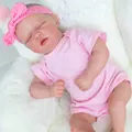Realistic 48cm reborn baby doll Skya in pink polka dot outfit sleeping on soft cushion - Pink / 19-inch