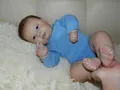 Detailed close-up of reborn baby boy Joseph with blue eyes in a light blue jumpsuit - Blue Bodysuit Style (60cm)