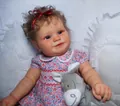 Detailed close-up of 60cm Maddie reborn baby doll in floral dress holding a plush donkey - Floral Red / 60 cm