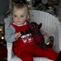58cm lifelike reborn baby doll in red velvet overalls sitting on a white woven chair - Red Velvet British Soldier Outfit Style / 58cm