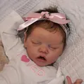Lifelike 18-inch reborn baby doll in a white Loved onesie with a pink ribbon headband - Cloth Body Style / Doll With Color Box