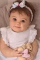 Detailansicht der 60 cm Reborn-Puppe mit realistischen Zügen und weißem Spitzenkleid - Ohne Plüschtier Stil / 60 cm