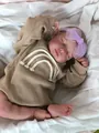 Detailed view of 49cm reborn doll in khaki waffle onesie with rainbow embroidery - Brown Romper / Full Vinyl Body