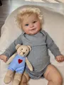 Macro detail of Maddie reborn doll with blonde curls, blue eyes and small teddy bear - Realistic Cloth Body Style (Without Plush Toy) / 60 cm