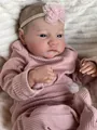 Close-up of Levi reborn doll featuring realistic skin texture and pink lace headband - Full Silicone Body Girl