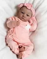Reborn doll Levi in pink striped outfit with matching headband on white plush blanket - Style 03 Cloth Body Doll