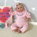 50cm realistic reborn baby doll in pink knit romper with floral headband and hand-painted hair - Pink Knitted Romper Style (2184) / Pink / 50 cm