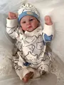 Close-up of Elijah reborn baby doll in cream bear romper on soft lace background - 49cm Cloth Body / Pink (2)