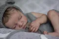 Close-up of lifelike newborn baby doll wearing gray bear ears knit hat and romper outfit - Full Vinyl Boy / Grey Style
