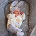 Close-up of baby romper with bunny embroidery and matching rabbit ear knitted hat - Hand Painted Hair / Full Silicone Style