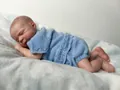 Close-up of realistic newborn baby doll skin textures and blue knit outfit details - 48cm / Light Blue (Cloth Body)