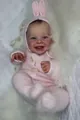 Close-up of lifelike baby doll face with pink knit rabbit hat and realistic skin details - 50 cm / Cloth Body Doll