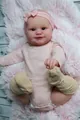 Detailed close-up of Maddie reborn doll in pink outfit on a soft plush rug - Cloth Body Style / Pink / 50cm