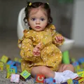 Lifelike reborn baby doll Missy with blue eyes, brown curls, and yellow floral dress - Large Size (60cm) / Ginger Yellow Floral Style