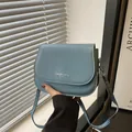 Sky blue minimalist saddle bag with magnetic flap and fashion trend logo detail - Blue