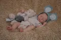 49cm reborn baby doll in beige romper and blue hat with mini bear plush toy - Beige Romper With Blue Mouse Ear Hat (2165) / 49cm Height