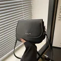 Minimalist black matte leather saddle bag for women with adjustable shoulder strap - Black