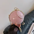 Roze glitter bolvormige avondtas met goudkleurig ringhandvat en metalen ketting - Roze