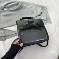Black ita-bag style backpack featuring a lace-up bow design and transparent window - Black