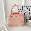Pink quilted tote bag with black bow patterns and dual woven handles for daily use - Pink