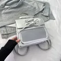 Metallic silver PU leather backpack with bow detail and mesh pocket on denim background - Silver