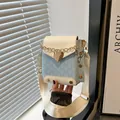 Mini crossbody bag in light blue monogram print with heart clasp and wide strap - White