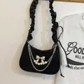 Black velvet crescent shoulder bag with metallic bow and pearl chain charm accents - Black