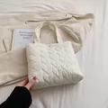 Minimalist beige quilted tote bag with heart pattern and gold clasp for women - White