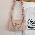 Pink crescent underarm bag with silver bow buckle and pearl chain detail - Pink