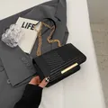 Minimalist black square shoulder bag with V-shaped quilting and gold metal chain strap - Black