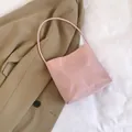 Light pink nylon bucket bag featuring 'pretty and libety' print and slim strap - Pink
