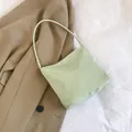 Light green casual tote bag with Pretty and Liberty text paired with beige trench coat - Green