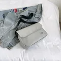 Light gray casual messenger bag with adjustable black strap and flap cover design - Gray