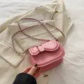 Pink saddle crossbody bag in faux leather with a stylish silver chain strap - Pink