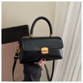 Elegante bolso bandolera negro con cierre cuadrado dorado y asa superior rígida - Negro