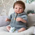 Realistic 49cm Levi Awake reborn doll in grey knit outfit on a cozy swing chair - Cloth Body