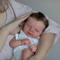 Lifelike 19-inch reborn baby doll in white cotton romper showing realistic skin details - As Shown / 50 cm