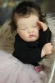 Close-up of sleeping reborn doll with realistic skin and black hair in pink tutu skirt - Cloth Body Style / Normal Specification