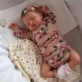Realistic 49cm Rosalie newborn baby doll in floral romper sleeping on a soft blanket - Rooted Hair Style / 49cm