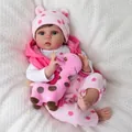 55cm lifelike reborn baby doll in pink polka dot outfit with a giraffe plush toy - 55 cm / Pink