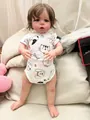 Detail of a 60cm lifelike reborn baby doll Sandie in a cat printed white romper outfit - Printed Onesie Style / Nude / 60 cm