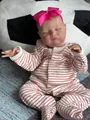Detailed close-up of 20 inch reborn baby doll with 3D skin texture in striped outfit - Cloth Body Style