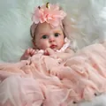 Close-up of lifelike 19-inch reborn baby doll with 3D skin texture and pink lace headband - Pink Lace Dress Style / 48cm Cloth Body