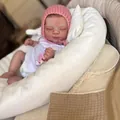 Lifelike 50cm sleeping reborn baby doll in pink knit hat and white romper on a soft pillow - Full Silicone Style / 50cm Full Silicone Style